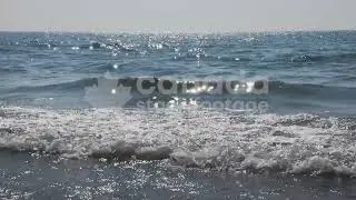 Slow motion sunlit waves breaking stock video. Prince Edward County, Lake Ontario, Canada. HD.