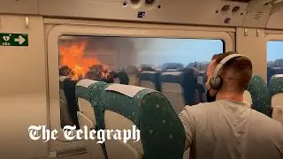 Terrifying moment wildfires surround stopped train in Spain