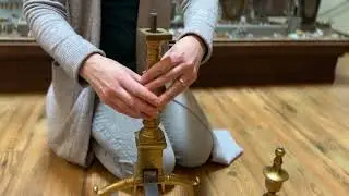 Gill demonstrating how to assemble Andirons