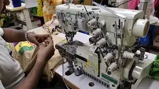 very skill operator. bottom hem of t shirt. Best industrial flatlock sewing machine. knit garments.