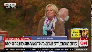 Joe Biden wanders around the stage as his wife Jill Biden speaks