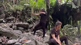 The girl visits traps and makes bows and arrows to hunt
