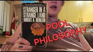 a reader laying at the bottom of the pool reads