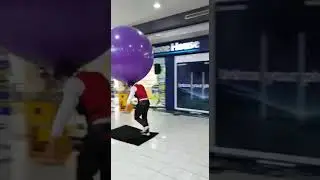 A man playing with a huge purple balloon!! 😮😮😮😮