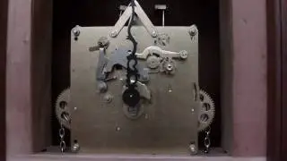 Grandfather clock movement chimes off.
