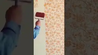 A man applying floral patterned wallpaper on wall #shorts