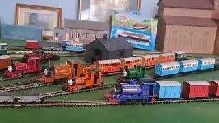 Bachmann Rusty Pulling 1 blue coach, 2 grey slate wagons and red brakvan