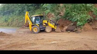Jcb backhoe loader clearing road block