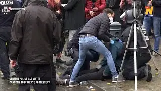 German police use water cannons to disperse protesters