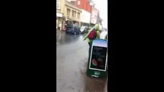 Water pours down Glastonbury High Street during storm