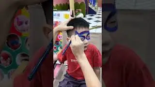 🎨 Transforming a little hero with superhero face paint! 💥