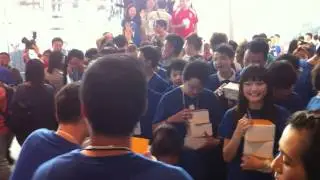 Entering the Apple Store, staff handing out T-shirts.