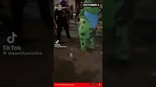 🐸🚨 Portland chaos: DHS officer maces Antifa frog costume during protest.