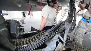 Air force weapons loaders arm F-15 fighters