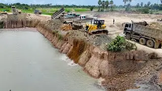 Creative Land Filling Deep Pond Using Operator Bulldozer and Dump Trucksto Move Soil into Large Pond