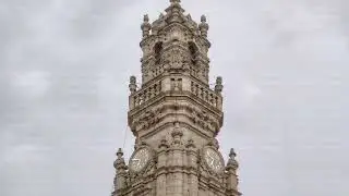 Bell tower of the Clerigos Church in cloudy blue sky background timelapse