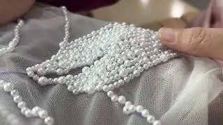 We designed a handmade pearl wedding dress that is very slimming.