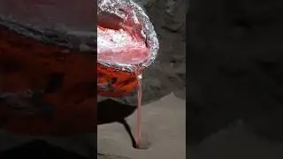 Pouring molten metal into a clay mold