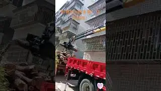 A small truck is equipped with a knuckle boom crane and a clamp saw, which can be used for sawing