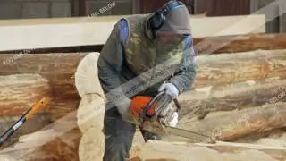 Man makes curly cutting wood Chainsaw. The log will be part of the future of the wooden house