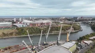 SUNDERLAND STADIUM OF LIGHT SAFC  ,NEW FOOT BRIDGE AND LIEBHERR CRANES AND BOB STOKOE