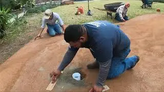 Setting or Installing putting green cups with mortar in a synthetic backyard putting green.