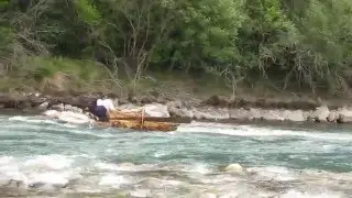 Traditional raft split in two descending the Cinca river