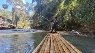 Bamboo rafting through the river at Chiang Mai mountains.
