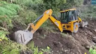 Jcb cutting road for village  in hilly area