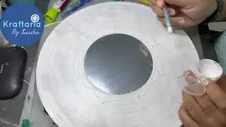 White on white dot mandala painting on MDF board.