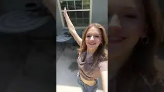 Jayden Bartels showing belly button, in nature.