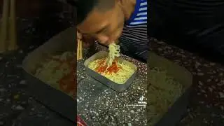 guy eating noodles
