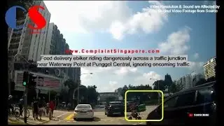 Food Delivery Ebiker Riding Dangerously Across A Traffic Junction Near Waterway Point