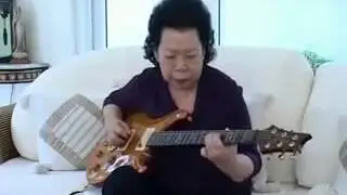 OLD WOMAN PLAYING BLUES with her guitar