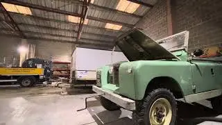 Hand cranking a 1959 landrover series 2 with a starting handle.