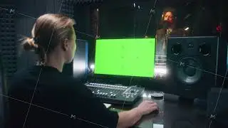 Female audio engineer works on PC in sound recording studio