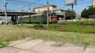 Class VL10 electric twin-unit locomotive  runs light out of St. Petersburg port area.mov