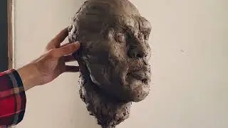 Sculpting African man  head in clay