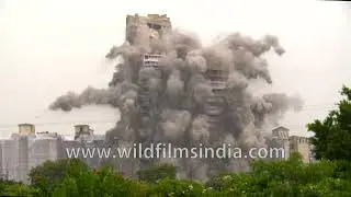 Two of the tallest towers to be demolished anywhere in the world come down in a controlled fashion