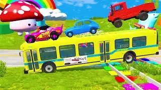 Yellow bus carrying three small cars on its back crosses the train rails