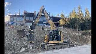 Cat 315 with Engcon building small boulder  retaining wall