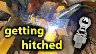 welding a hitch to the tractor