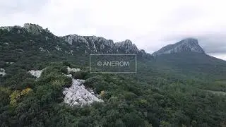 Aerial Drone Footage View: Flight over cloudy mountains. Pic Saint Loup, France, Europe.