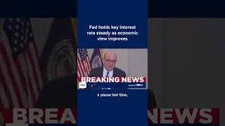 Fed holds key interest rate steady as economic view improves