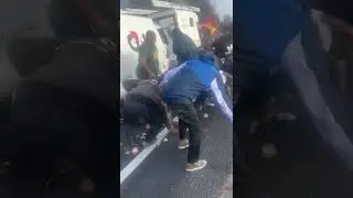 people collecting money from a G4s car involved in an accident