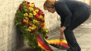 Historic Merkel visit to Nazi camp marred by controversy