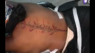 HER SPINE TATTOO WITH HER KIDS NAME .