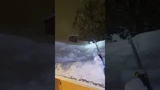 Raking snow off my house at night 