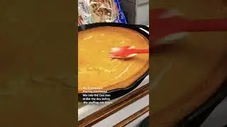 Ms. Champagne is putting butter on hot cornbread in the cast iron skillet