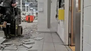 Removing ceramic flooring tiles and tile adhesive with Ride-On floor scraper.